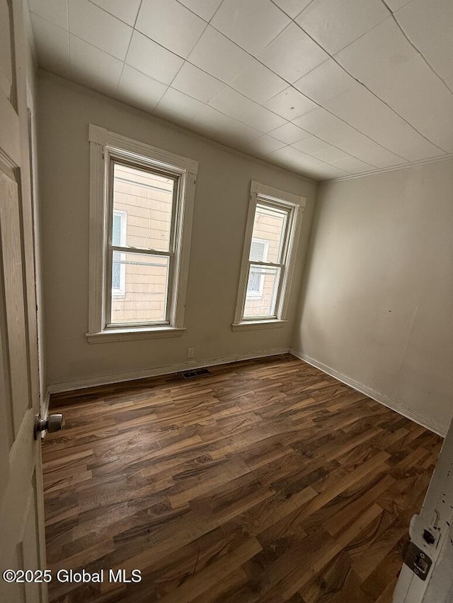 empty room featuring dark hardwood / wood-style flooring