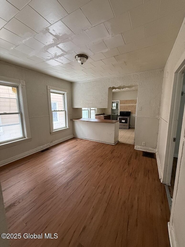 unfurnished living room featuring wood-type flooring