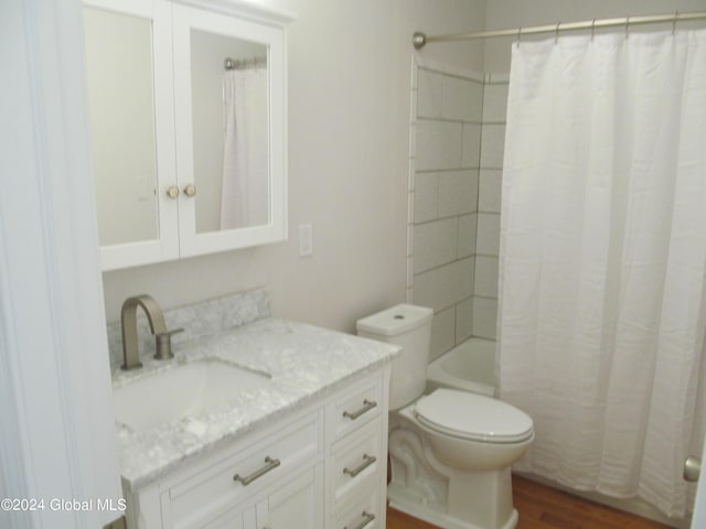 bathroom featuring shower / bath combo, wood finished floors, vanity, and toilet