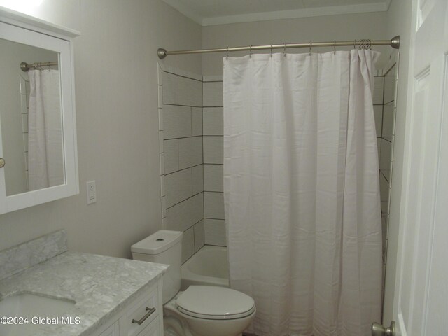 full bathroom featuring vanity, shower / bath combo with shower curtain, and toilet