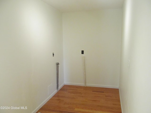 hall featuring baseboards and light wood-type flooring