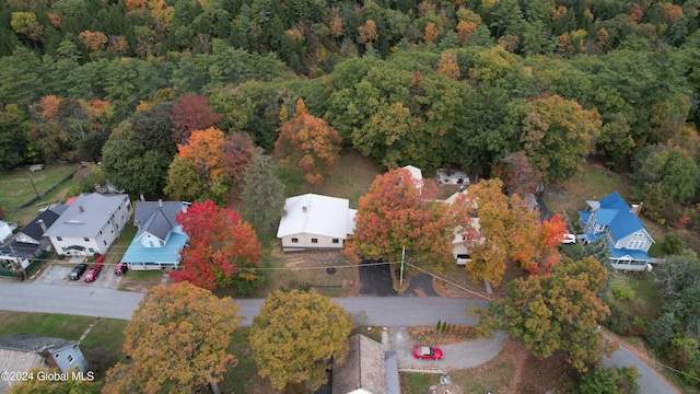 drone / aerial view featuring a wooded view