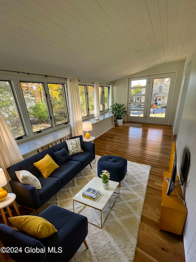 living room featuring light hardwood / wood-style flooring, wood ceiling, lofted ceiling, and plenty of natural light