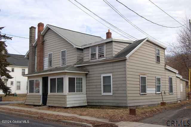 view of property exterior with a sunroom