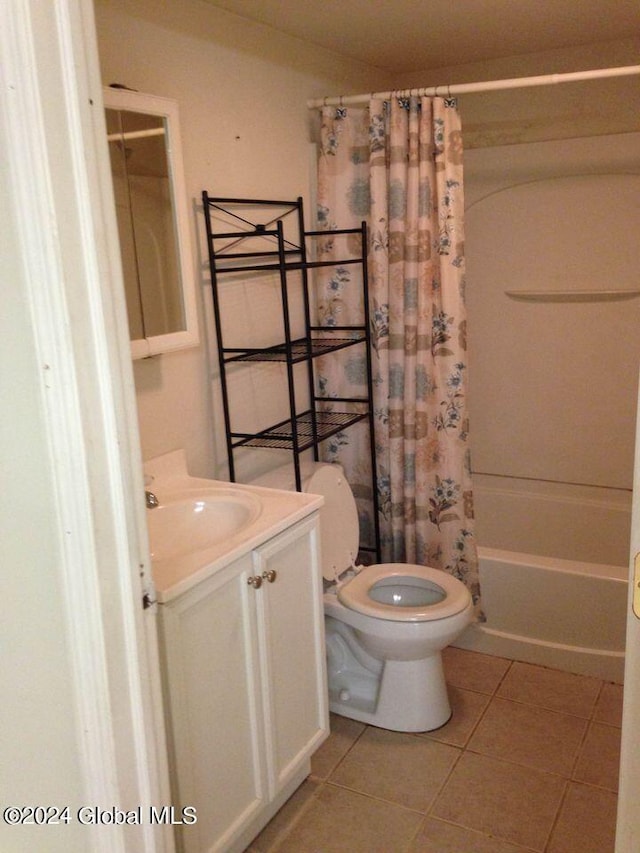 full bathroom with vanity, toilet, tile patterned floors, and shower / tub combo with curtain