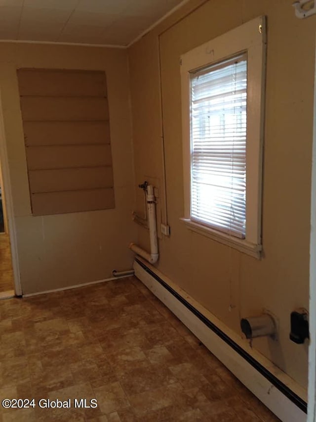 clothes washing area with a baseboard radiator