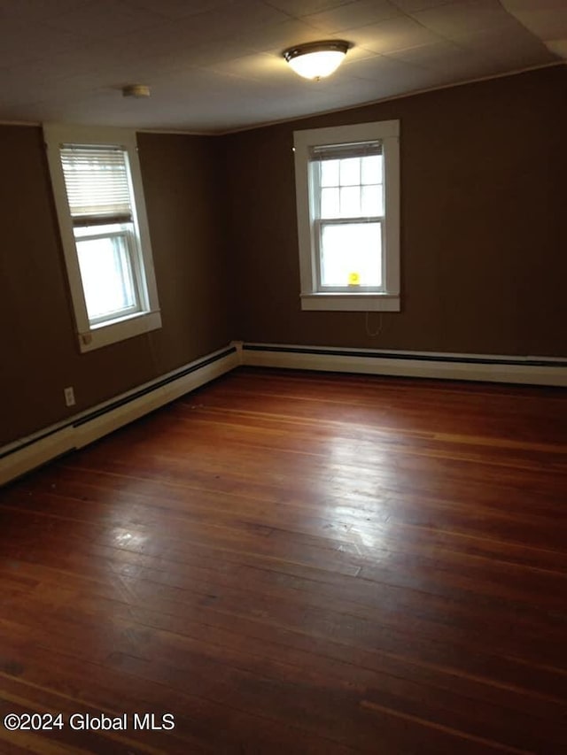 spare room with dark hardwood / wood-style flooring