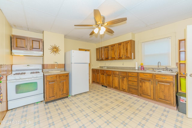 kitchen with sink, white appliances, and ceiling fan