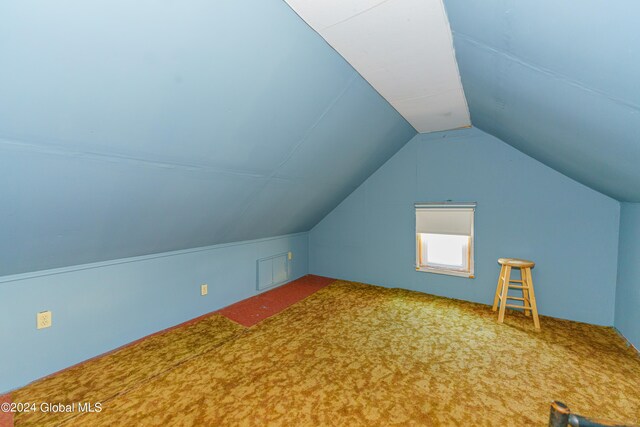 bonus room featuring vaulted ceiling and carpet floors