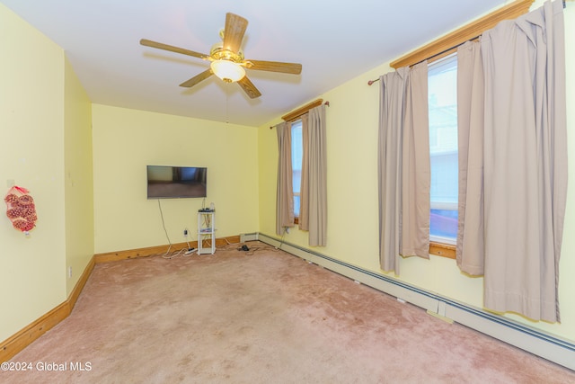 empty room featuring light colored carpet, a baseboard radiator, and ceiling fan