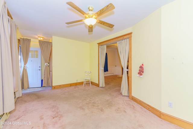 unfurnished room featuring light carpet, baseboard heating, and ceiling fan