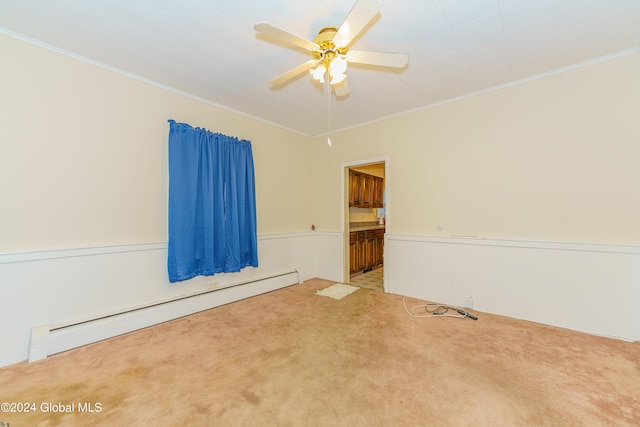 carpeted spare room with crown molding, a baseboard heating unit, and ceiling fan