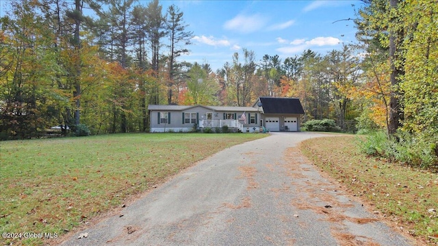 single story home featuring a front lawn and a garage