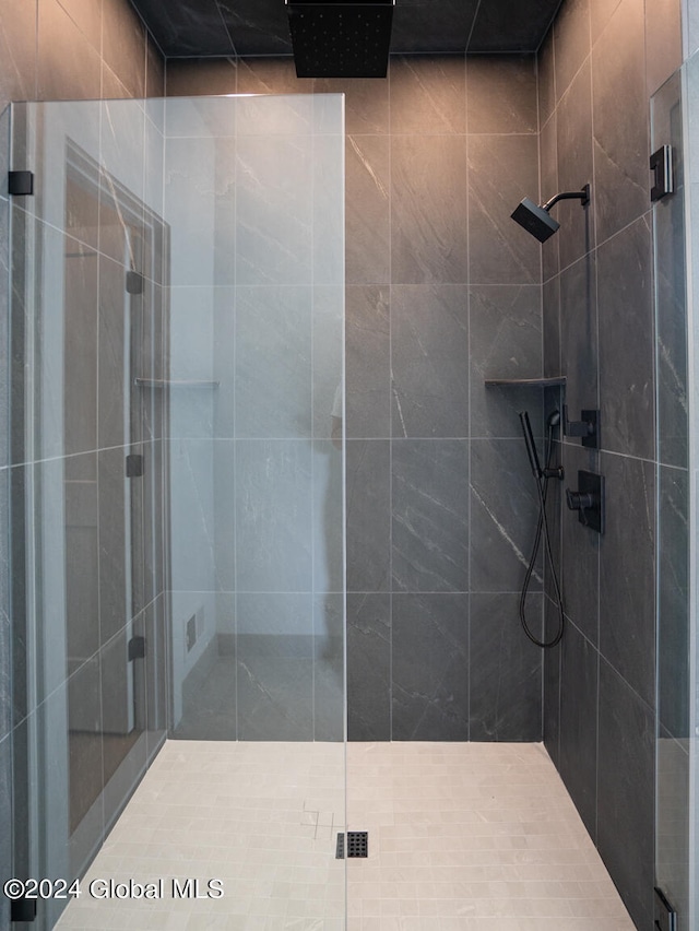 bathroom featuring a shower with shower door