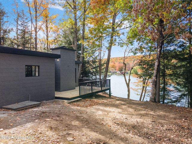 exterior space with a deck with water view