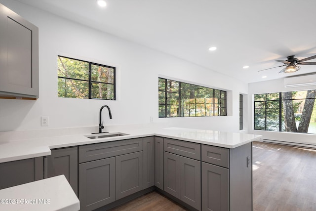 kitchen featuring a wealth of natural light and dark hardwood / wood-style floors