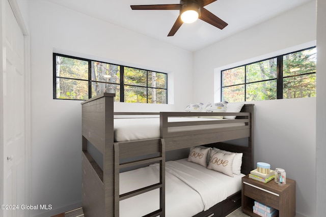 bedroom with multiple windows and ceiling fan