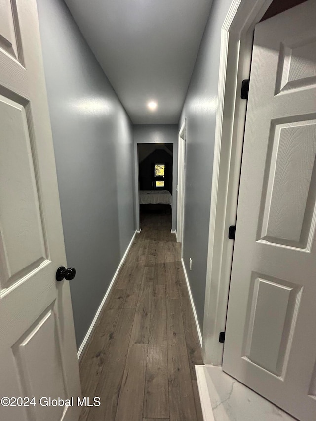 hallway with dark hardwood / wood-style flooring