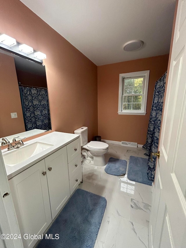 bathroom featuring vanity, toilet, and a shower with shower curtain