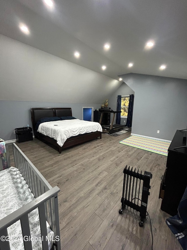 bedroom with lofted ceiling and hardwood / wood-style flooring