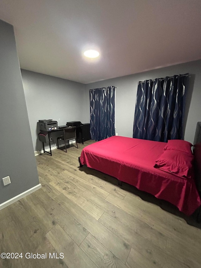 bedroom with hardwood / wood-style floors