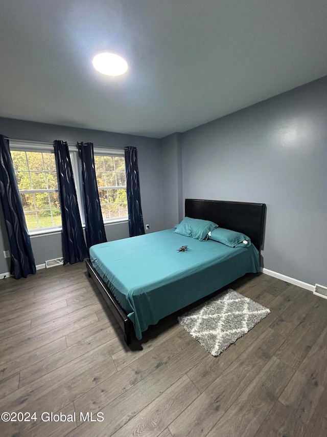 bedroom with hardwood / wood-style flooring