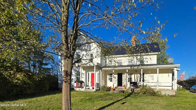 view of front facade with a front lawn and a porch