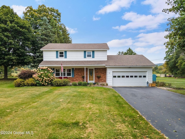 front of property with a front yard and a garage