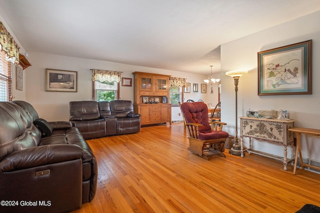 living room featuring an inviting chandelier and light wood-type flooring