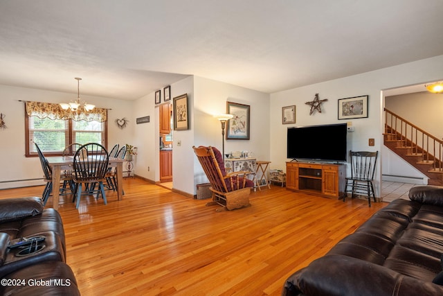 living room featuring hardwood / wood-style floors, baseboard heating, and a chandelier