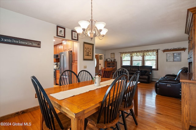 dining room featuring an inviting chandelier and light wood-type flooring