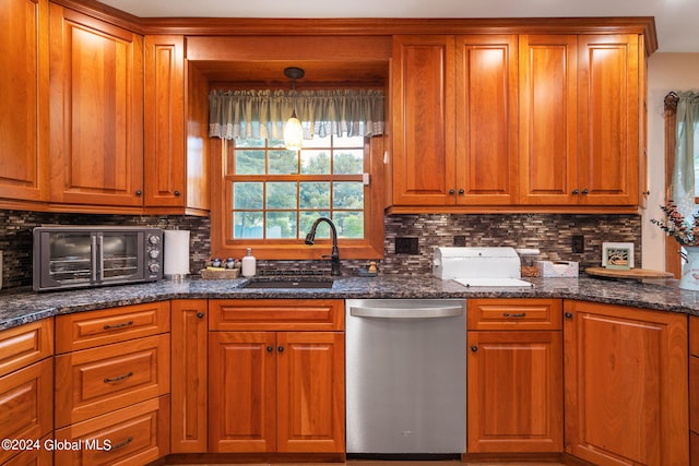 kitchen with sink, dishwasher, hanging light fixtures, and tasteful backsplash