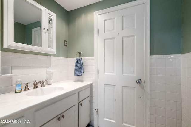 bathroom with tile walls and vanity