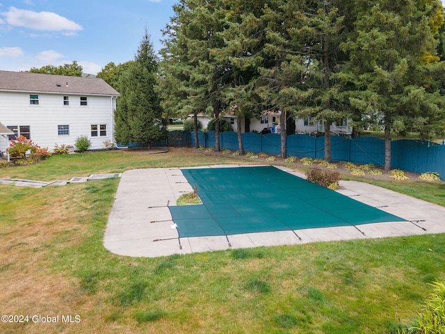 view of pool featuring a yard and a patio