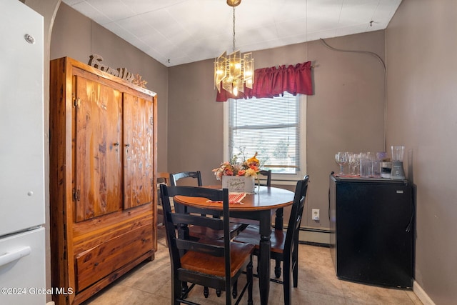 tiled dining room with an inviting chandelier