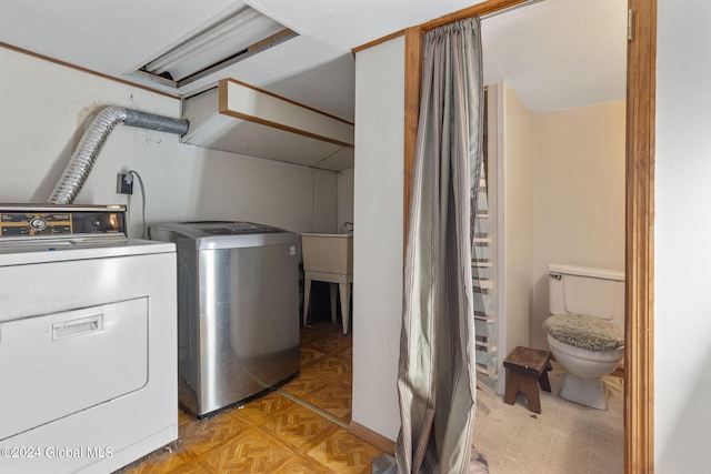 washroom featuring independent washer and dryer and light parquet flooring