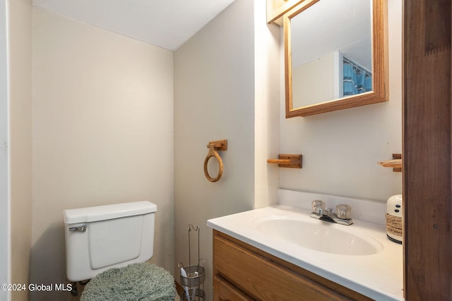 bathroom featuring toilet and vanity