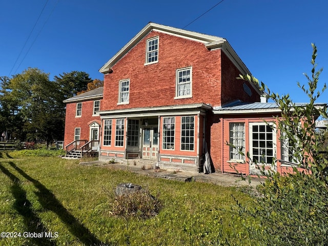 rear view of house with a yard