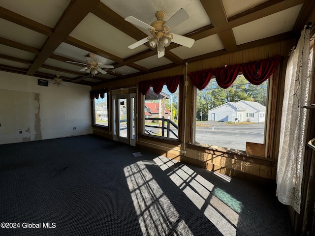 unfurnished sunroom featuring beamed ceiling, coffered ceiling, and ceiling fan