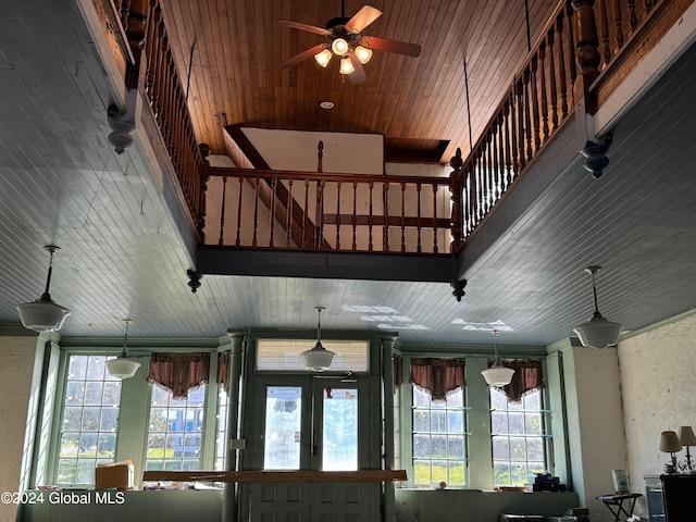 interior space featuring a balcony and ceiling fan