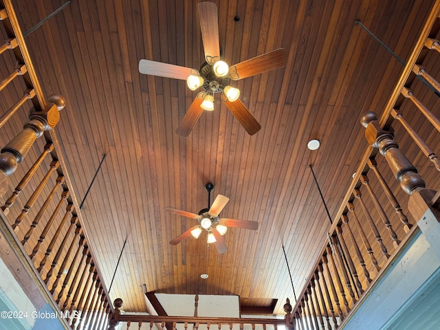 interior details featuring wood walls and ceiling fan