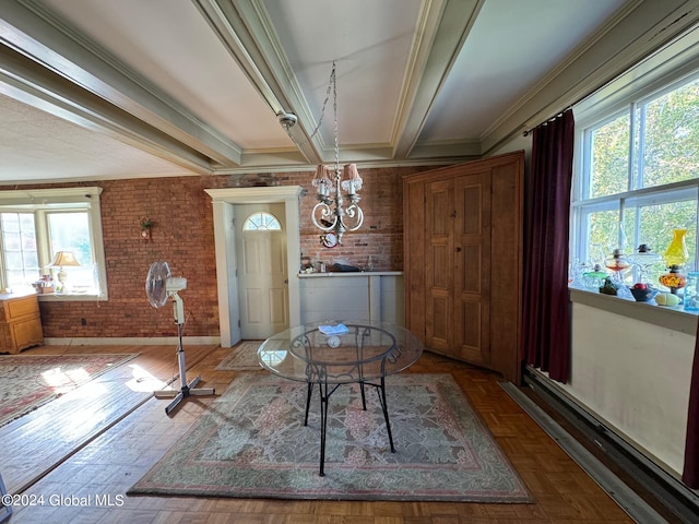 interior space with brick wall, ornamental molding, an inviting chandelier, and plenty of natural light