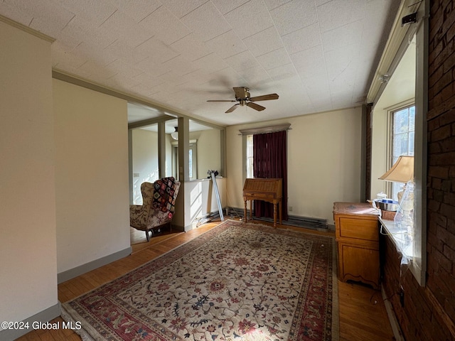 entryway featuring ceiling fan, light hardwood / wood-style flooring, and a fireplace