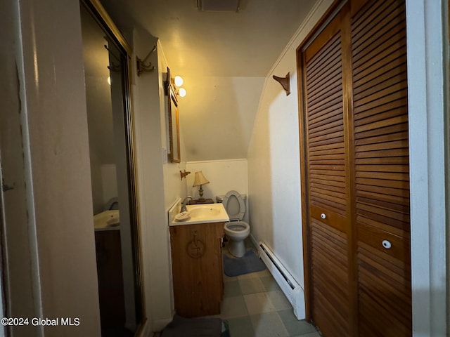 bathroom featuring toilet, baseboard heating, and vanity