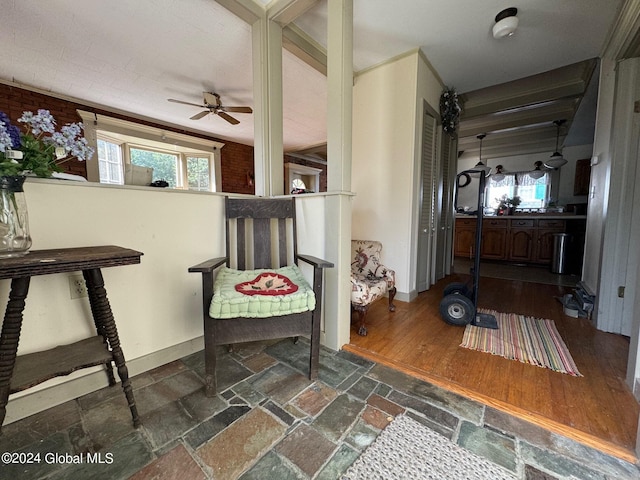 sitting room featuring ceiling fan and dark hardwood / wood-style floors