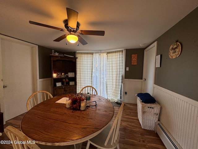 dining area featuring a baseboard radiator, ceiling fan, and dark hardwood / wood-style flooring