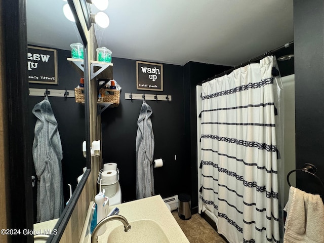 bathroom featuring vanity, baseboard heating, tile patterned floors, and a shower with shower curtain