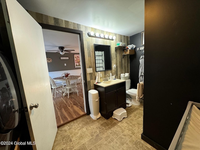 bathroom featuring vanity, hardwood / wood-style floors, toilet, and ceiling fan