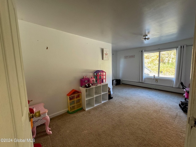 playroom with baseboard heating and carpet