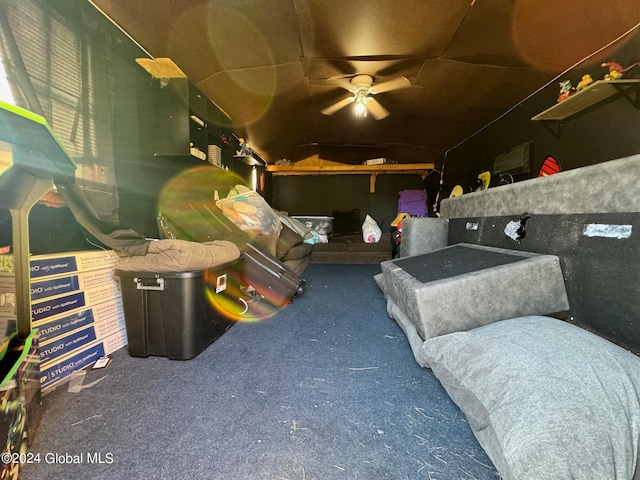 interior space with dark carpet and ceiling fan